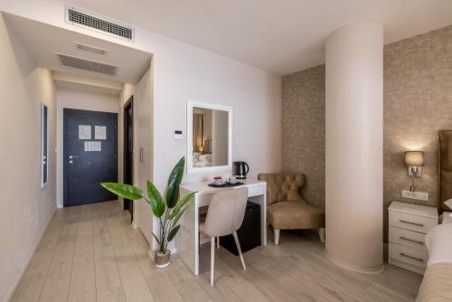 a hotel room with a desk and a chair at Sea View Luxury Rooms Seven of Nine in Split