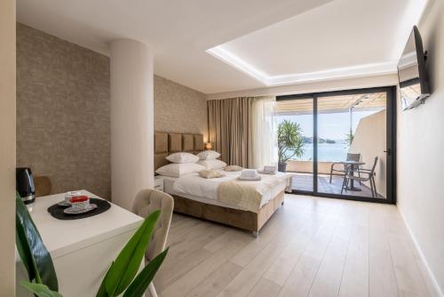 a hotel room with a bed and a view of the ocean at Sea View Luxury Rooms Seven of Nine in Split