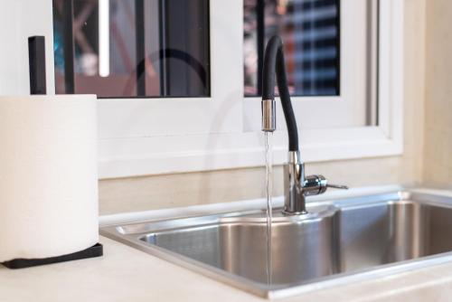 a kitchen sink with a faucet in a kitchen at DreamCoast Apartments I in Artemida