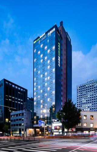 a tall building in a city at night at ibis Styles Ambassador Seoul Myeong-dong in Seoul
