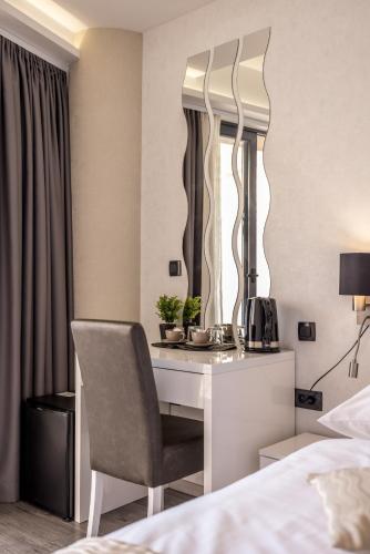 a bedroom with a desk with a chair and a mirror at Sea View Luxury Rooms Seven of Nine in Split