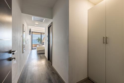 a hallway with white walls and wood floors and a door at Sea View Luxury Rooms Seven of Nine in Split