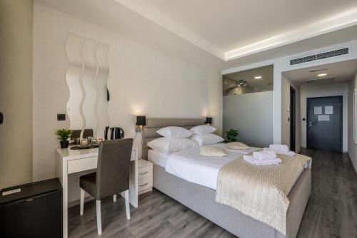 a bedroom with a large bed with a desk and a bed sidx sidx sidx sidx at Sea View Luxury Rooms Seven of Nine in Split