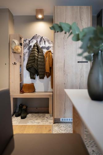 a room with a closet with coats and shoes at Résidence Pierre & Vacances Premium L'Hévana in Méribel