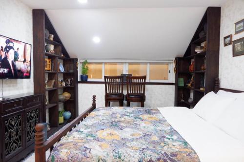 a bedroom with a bed and two chairs in it at The Rustic Home - Nguyên căn in Ho Chi Minh City