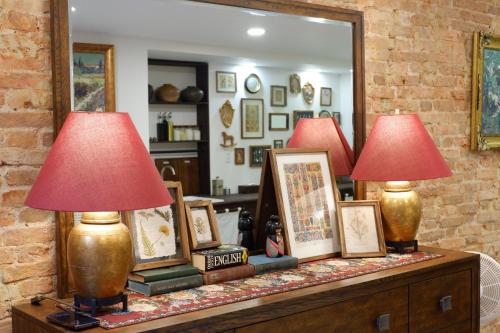 two lamps on top of a dresser with a mirror at The Rustic Home - Nguyên căn in Ho Chi Minh City