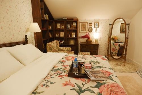 a bedroom with a bed with a table and a mirror at The Rustic Home - Nguyên căn in Ho Chi Minh City