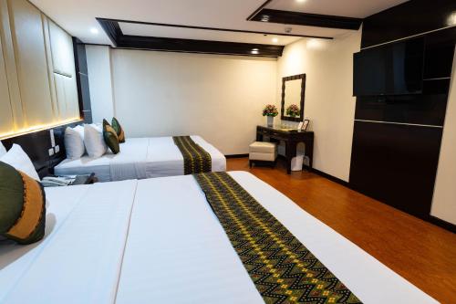 Ein Bett oder Betten in einem Zimmer der Unterkunft The Apo View Hotel