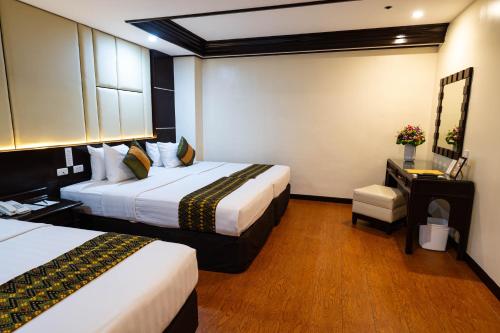 Ein Bett oder Betten in einem Zimmer der Unterkunft The Apo View Hotel