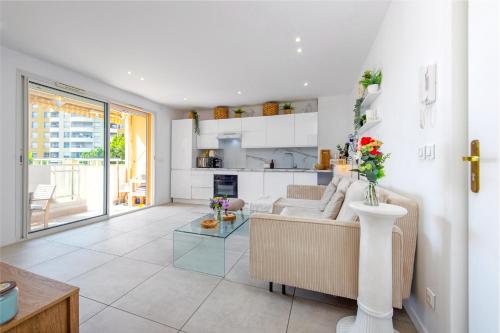 un salon avec un canapé et une table dans l'établissement PIERRE DE GEMMES - Agréable deux pièces - Menton - Parking Gratuit, à Menton