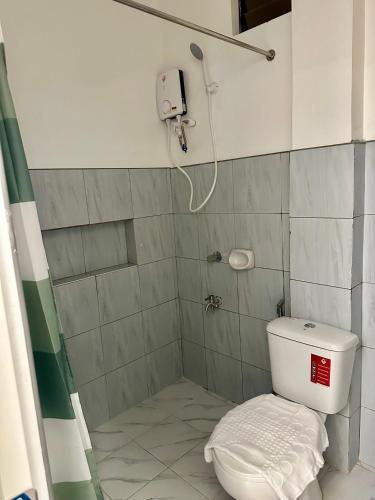 a bathroom with a shower with a toilet in it at Casa Vina El Nido in El Nido