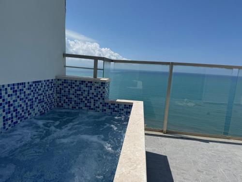a swimming pool on a balcony with a view of the ocean at Suite Rana Hedhun in Shëngjin