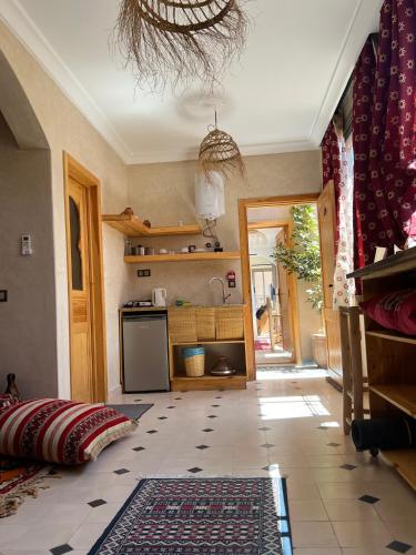 a kitchen with a tile floor and a kitchen with a stove at SurfAppart Morocco in Tamraght Ouzdar