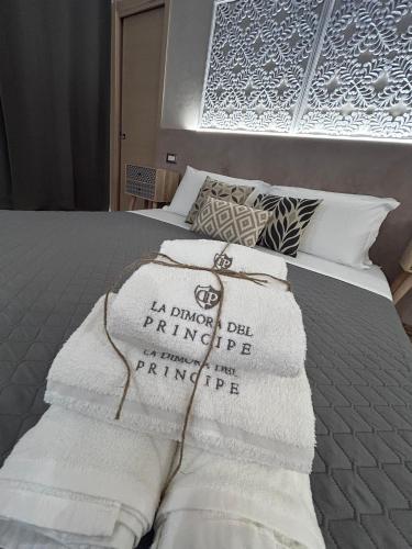 a bed with towels on top of it at La Dimora del Principe-Piano terra in Trani