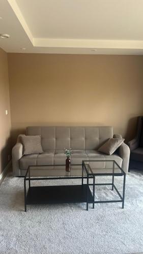 a living room with a couch and a coffee table at Moderne Leilighet med panorama utsikt in Sandefjord