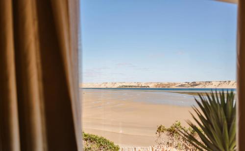 a view of a beach from a window at New Spirit Dakhla in Dakhla