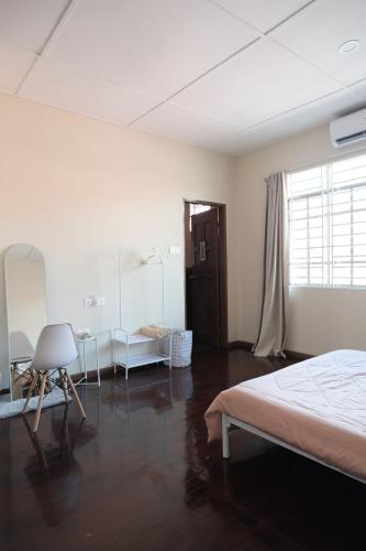 a bedroom with a bed and a table and a window at Kim_Homestay in Tawau