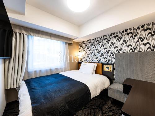 a hotel room with a bed and a desk at APA Hotel Asakusa Kaminarimon Minami in Tokyo