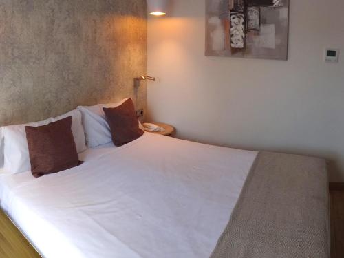 Postel nebo postele na pokoji v ubytování Hotel Lloret Ramblas