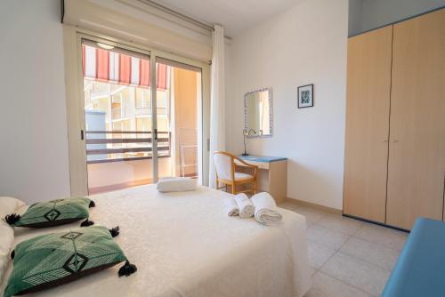 Postel nebo postele na pokoji v ubytování Residence La Rosa di Nettuno