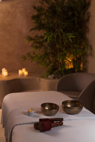 two bowls on a table with two candles on it at Approdo Resort Thalasso Spa in Castellabate