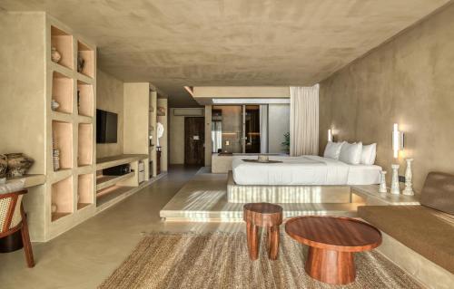 a hotel room with a bed and a couch at Café del Mar Phuket - Suite & Penthouse in Kamala Beach