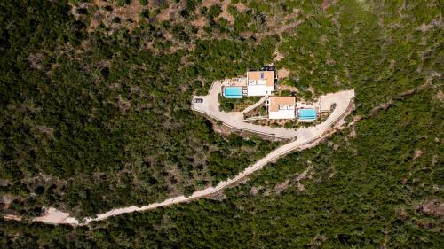 an aerial view of a house in a forest at Alfresco Villas in Sivota