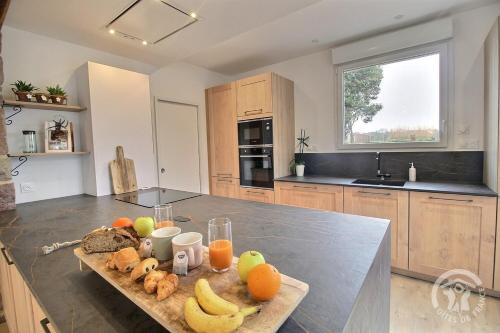 a kitchen with a table with fruit on it at La maison de oueval in Frehel