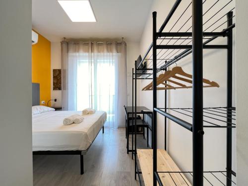 a bedroom with a bed and a spiral staircase at RRRapido Colorful Rooms - Assago in Assago