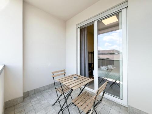 a room with a table and chairs on a balcony at RRRapido Colorful Rooms - Assago in Assago