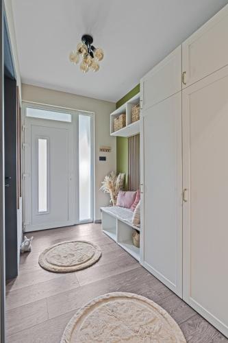 a living room with a closet and a rug at Ház a Hold utcában in Kehidakustány
