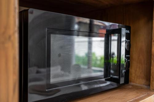 a toaster oven with a window in a kitchen at Kuta Beach Villas by Great Bali Villas in Badung