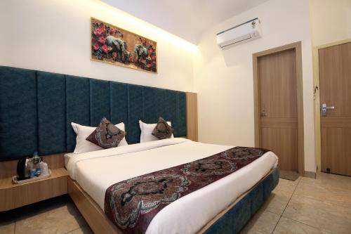a bedroom with a large bed in a room at Park Plaza Hotel Near Golden Temple in Amritsar