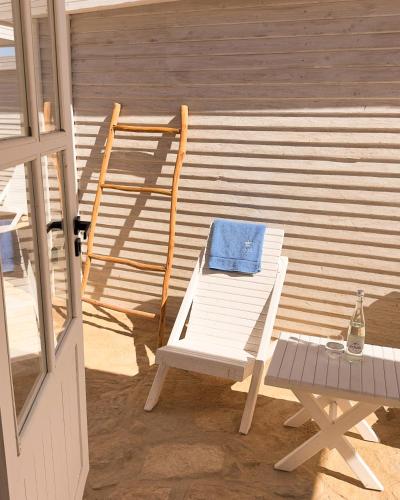 a white chair and a table next to a building at New Spirit Dakhla in Dakhla