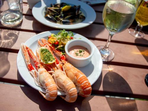 a plate of food with lobsters on a table at Holly Tree Hotel, Swimming Pool & Hot Tub in Glencoe