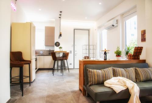 a living room with a couch and a kitchen at Wabi Sabi suite in San Benedetto del Tronto
