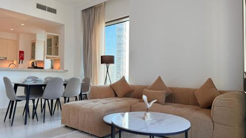 a living room with a couch and a table at Premium 2 Bedroom Creek Horizon in Dubai