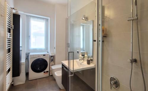 a bathroom with a shower and a sink and a toilet at Comfortable apartment in the heart of Lecco in Lecco