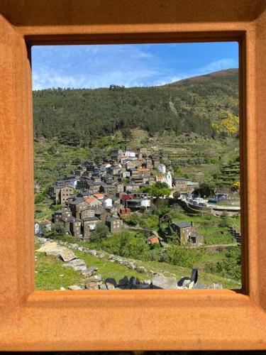 a view of a city from a window of a town at Casinha da Deolinda in Aldeia das Dez