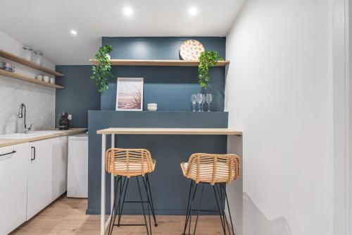 une cuisine avec une table et deux tabourets dans l'établissement Petit cocon provençal à 2mn d'Arles, à Fourques