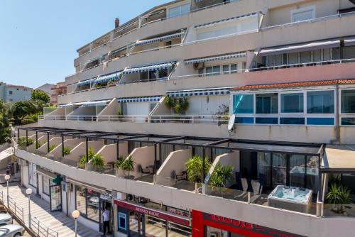 an apartment building with plants on the balconies at Sea View Luxury Rooms Seven of Nine in Split