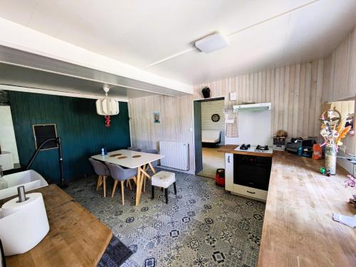 une cuisine et un salon avec une table et une cuisine et une table dans l'établissement Maison T3 dans moulin à eau, à Sainte-Marthe