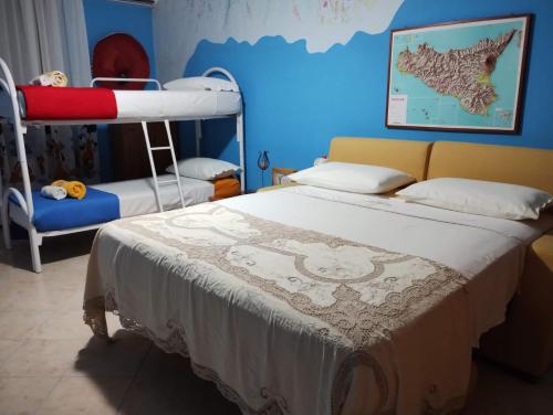 a bedroom with a bed and a bunk bed at PignaRossa Appartamenti in Mongiove
