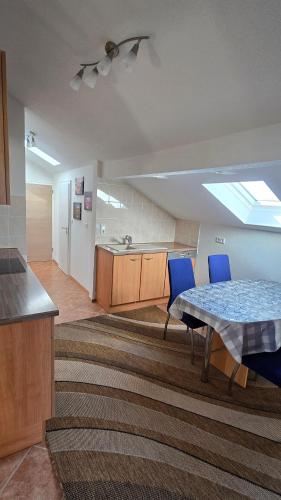 a living room with a table and blue chairs at Ferienwohnung Chiemsee in Chieming