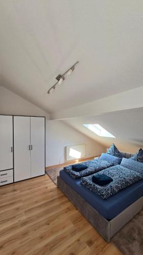 a bedroom with a bed and a white cabinet at Ferienwohnung Chiemsee in Chieming
