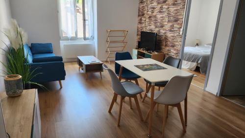 a living room with a table and chairs at Appartement tout confort vue sur les forts in Salins-les-Bains