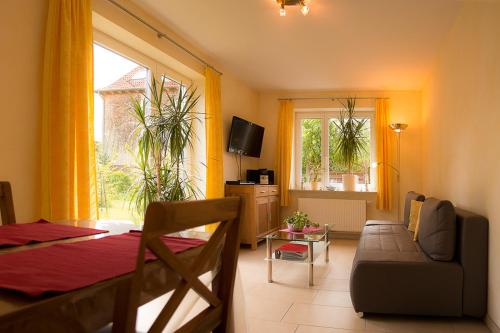 a living room with a table and a couch and a room at Familie Schwantes in Buxtehude