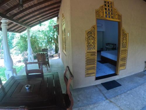 a room with a bed and a mirror on the wall at Kirindioya Village Safari Lodge in Tanamalwila
