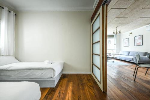 a bedroom with two beds and a mirror at Country Style 3BR Apartment 2min from the Beach with Shelter by Sea N Rent in Tel Aviv