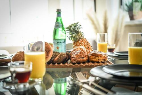a table with a plate of bread and a bottle of beer at Country Style 3BR Apartment 2min from the Beach with Shelter by Sea N Rent in Tel Aviv